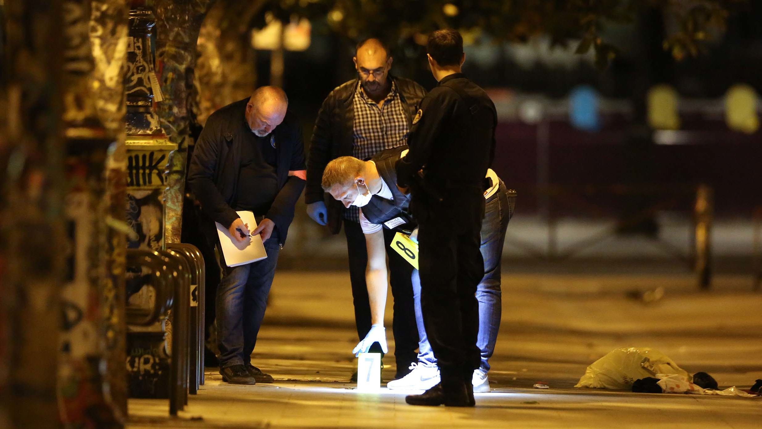 French police investigate the scene where a man attacked people with a knife Sunday night in Paris.