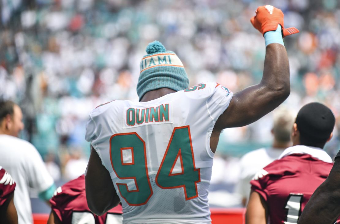 Quinn raises his fist during the national anthem against the Tennessee Titans.