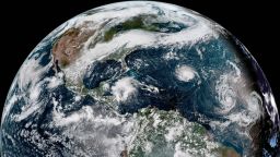 This enhanced satellite image provided by NOAA shows Hurricane Florence, third from right, in the Atlantic Ocean on Sunday, Sept. 9, 2018. At right is Tropical Storm Helene, and second from right is Tropical Storm Isaac. (NOAA via AP)