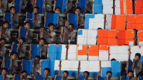 Children hold placards during the Mass Games.