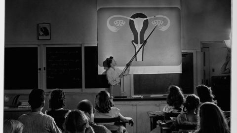 A teacher points to a diagram of female reproductive organs projected on a screen in a classroom in a scene from "Human Growth," an education film on sex education shown to students in Oregon junior high schools beginning in 1948.