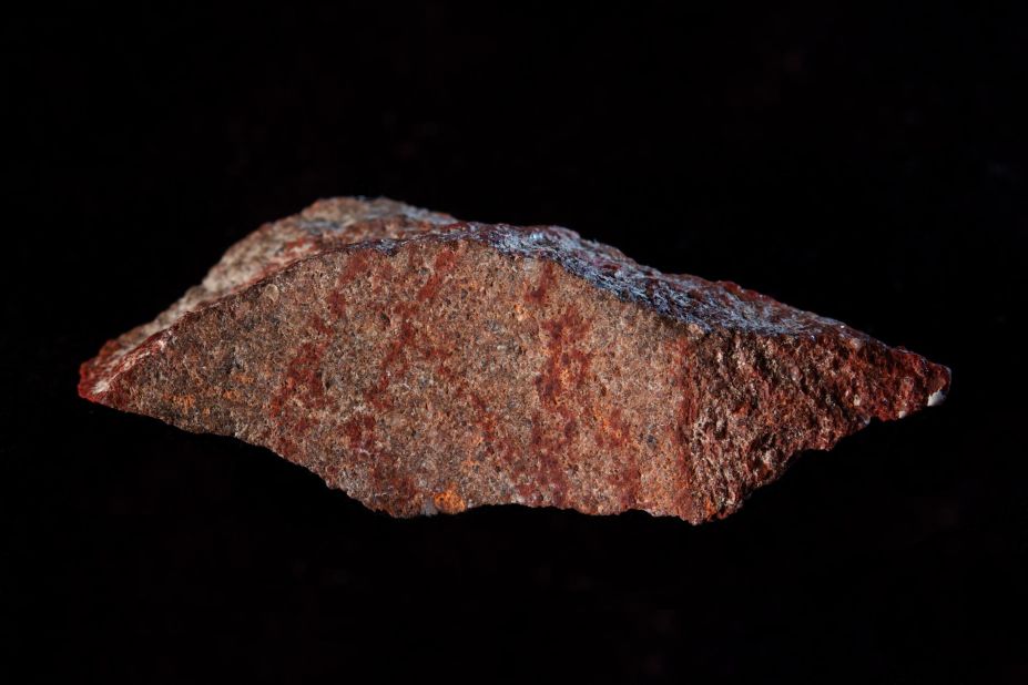 A 73,000-year-old red cross-hatch pattern was drawn on a flake of silicrete, which forms when sand and gravel cement together, and found in a cave in South Africa.