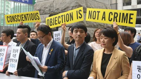 South Korean activists and conscientious objectors to military service are seen during a rally outside the Constitutional Court in Seoul on June 28.