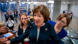 FILE - In this Aug. 21, 2018, file photoSen. Susan Collins, R-Maine, speaks with reporters on an escalator at the Capitol in Washington. John McCain is being remembered as a last lion of the Senate, with few others matching his stature. (AP/J. Scott Applewhite, File)