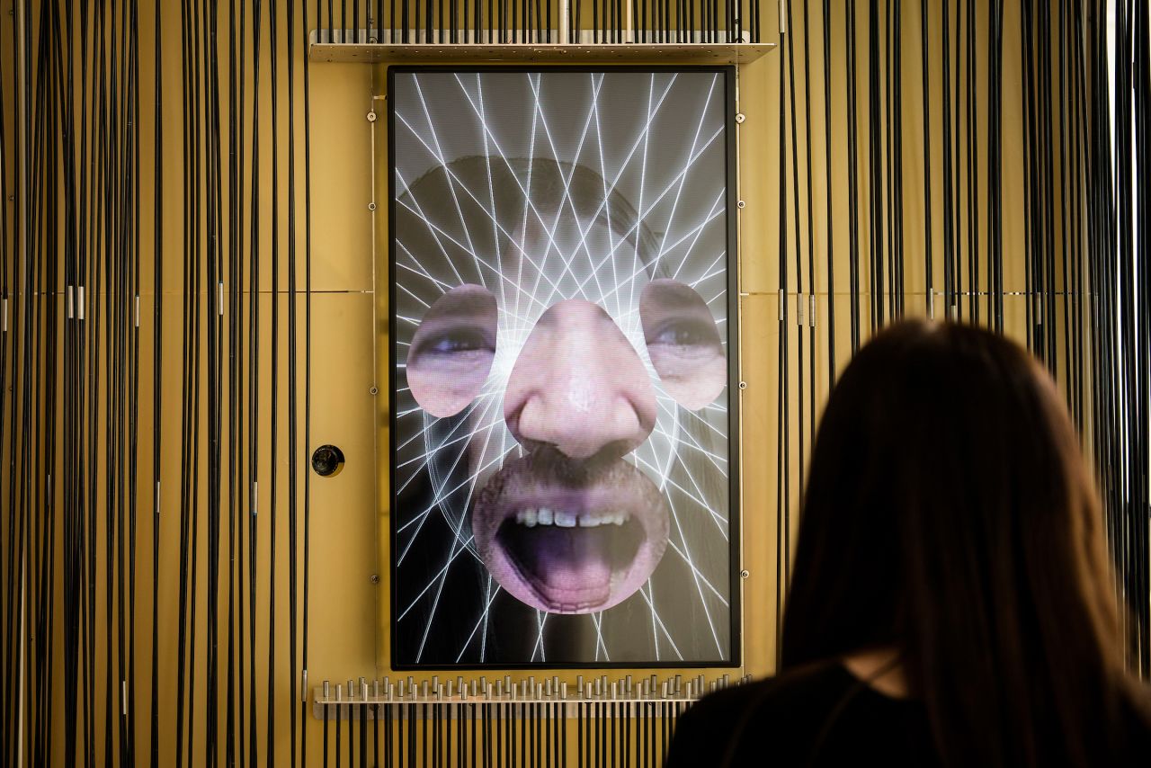 A visitor interacts with Zachary Lieberman's Expression Mirror in Cooper Hewitt's "Face Values" installation at the 2018 London Design Biennale. Photo David Levene.