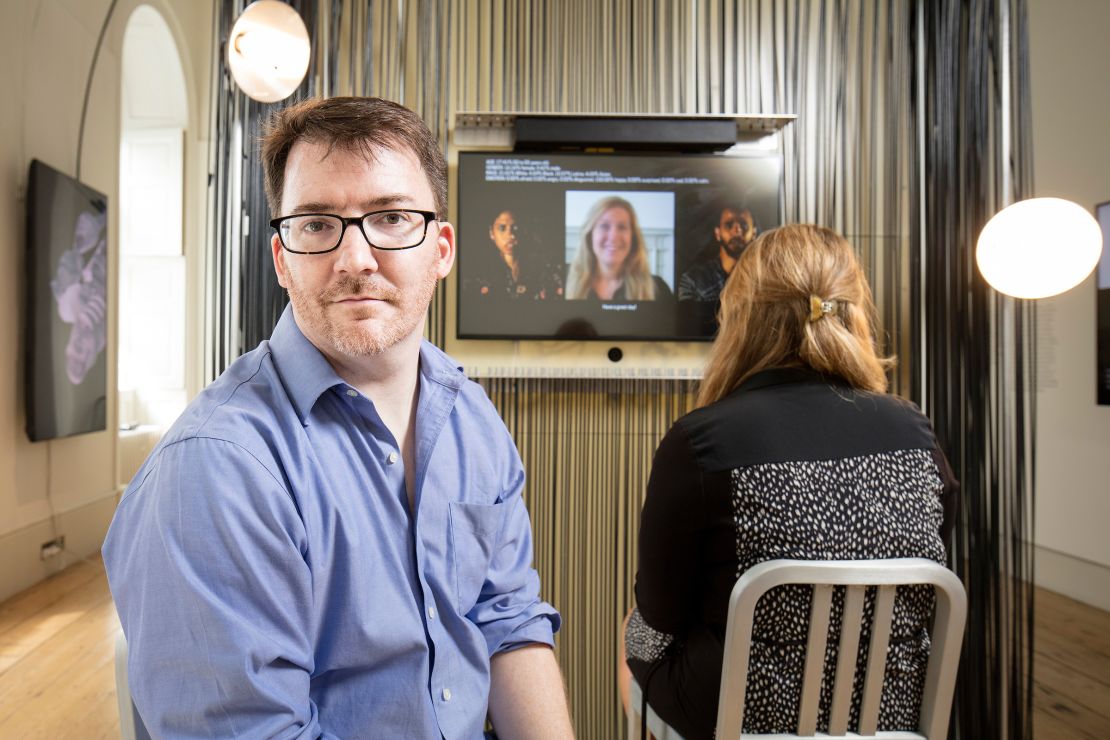 R. Luke DuBois photographed with his work in Cooper Hewitt's "Face Values" installation.