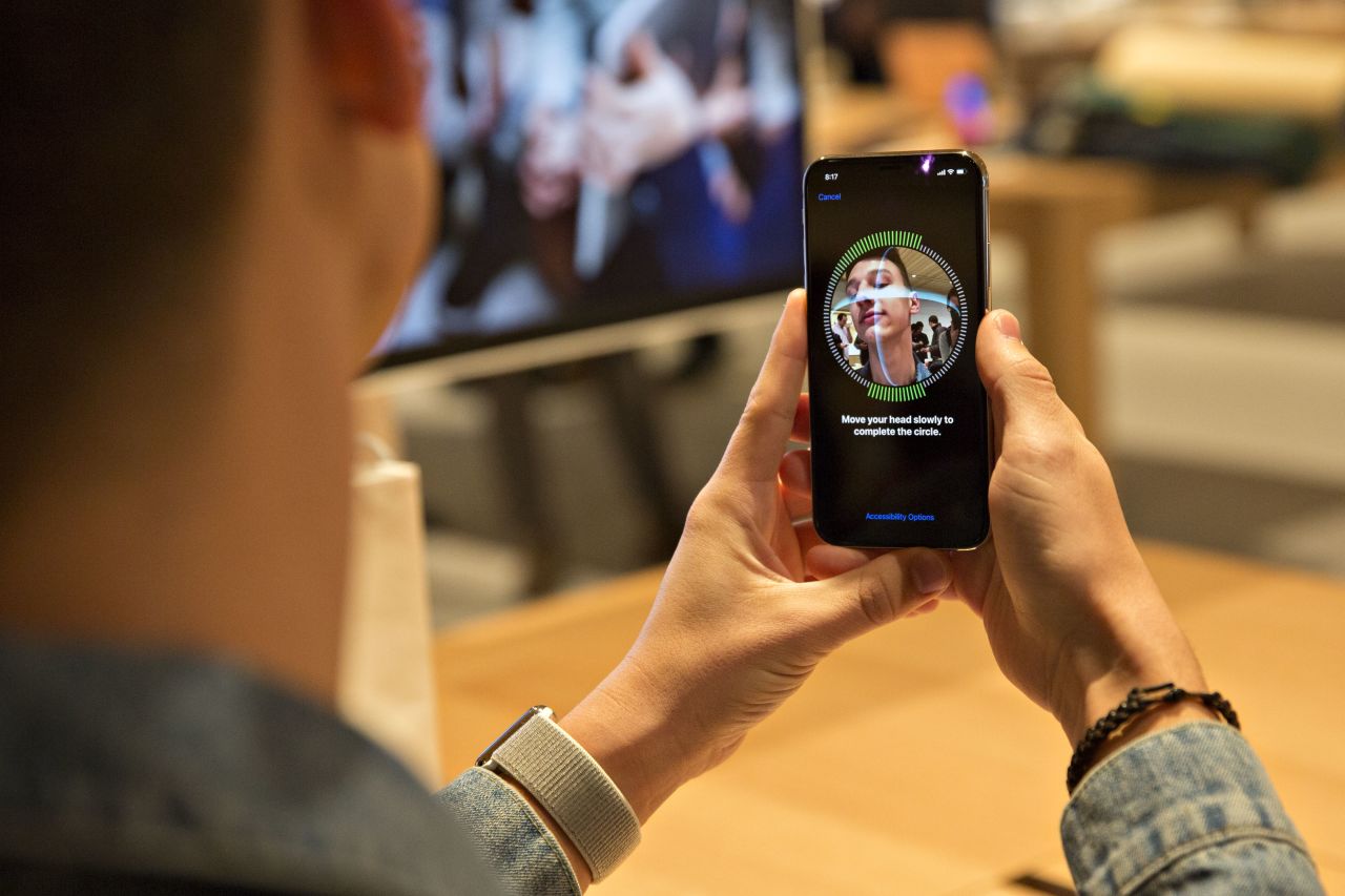 A customer sets up facial recognition on an iPhone X. 