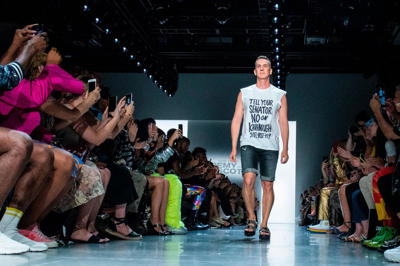 Jeremy Scott walks his own runway in a shirt that says "Tell Your Senator No on Kavanaugh." 