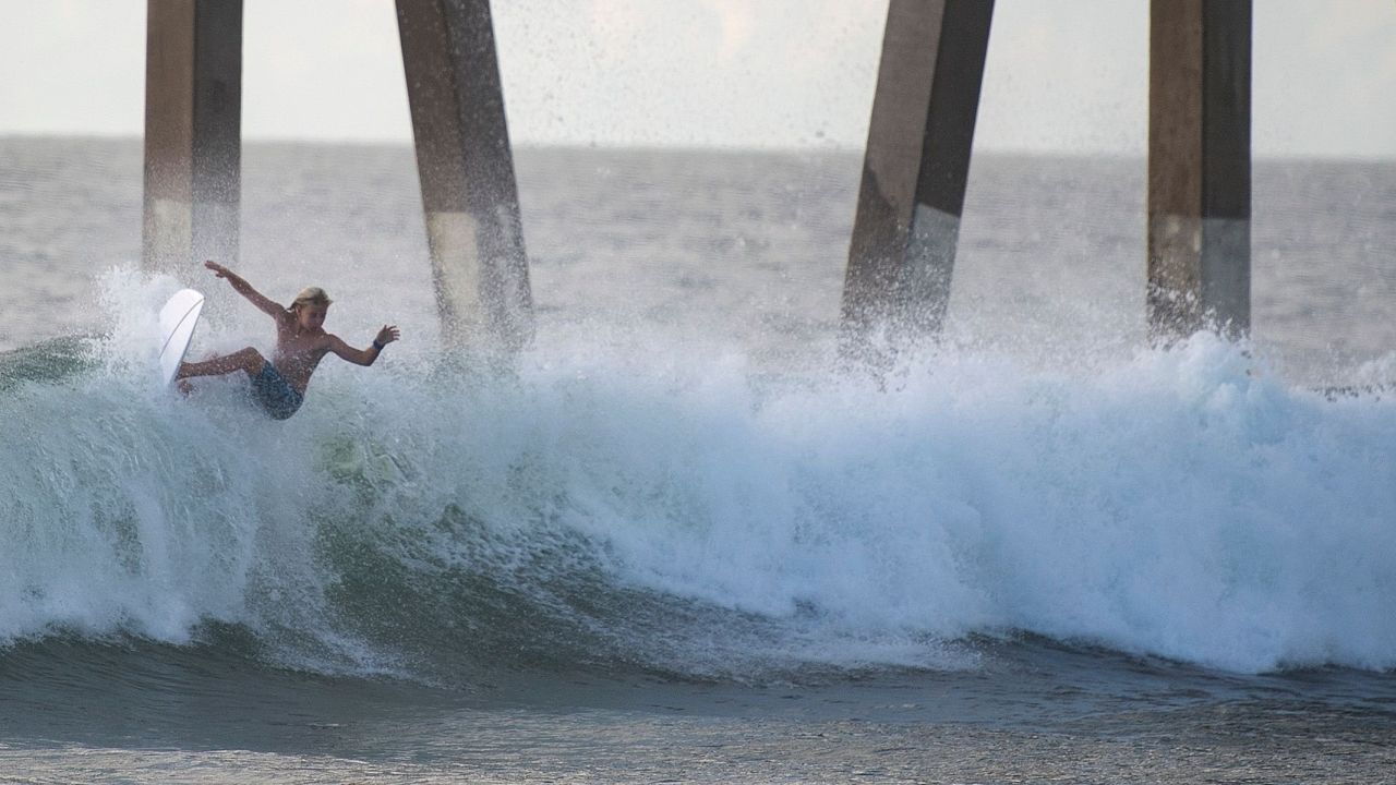 A surfer catches a wave  at Wrightsville Beach, North Carolina, on Wednesday afternoon. 