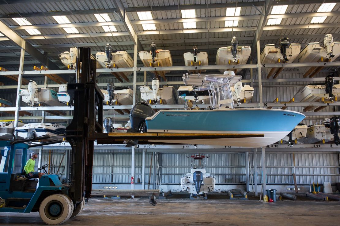 A worker at a marina in Swansboro, North Carolina, hurries to move boats into storage on Wednesday.