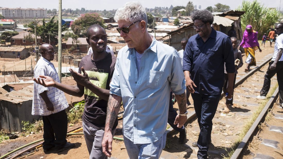 Bourdain walks with Bell in Nairobi's Kibera slums in February 2018 during the filming of "Parts Unknown" Season 12. 