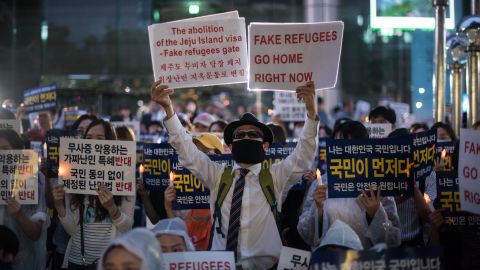 Anti-immigration activists attend a protest against a group of asylum-seekers from Yemen, in Seoul on June 30, 2018.