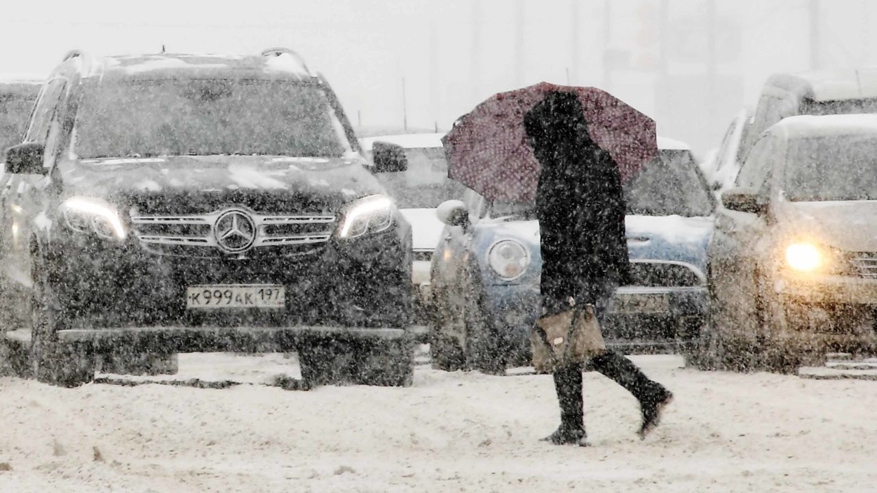 A woman walks through heavy snowfall in a Moscow suburb on March 4, 2018.