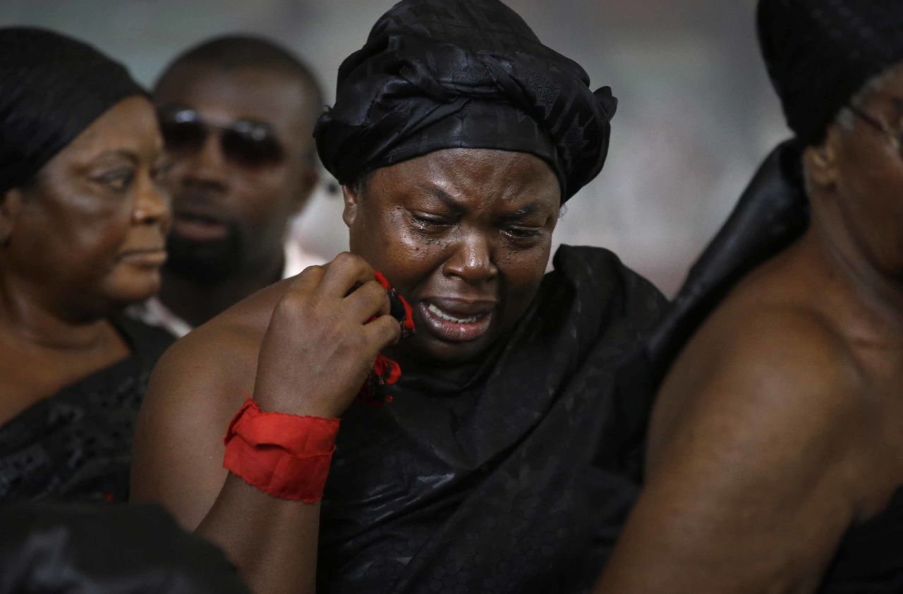 A woman mourns near Annan's coffin on September 12. The ceremony marked the end of three days of mourning declared in Ghana.