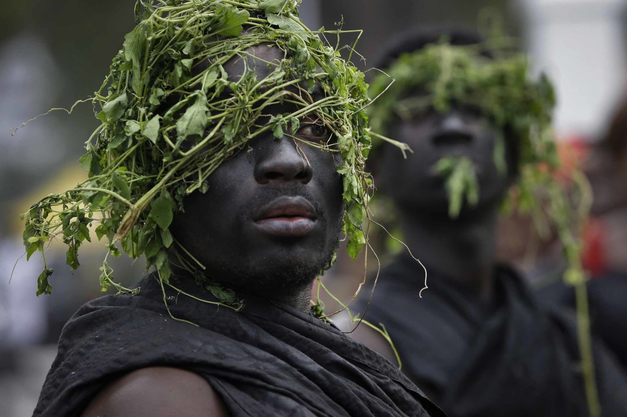 Guards of a Ghanaian chief wear plants on their heads as part of a funeral tradition.