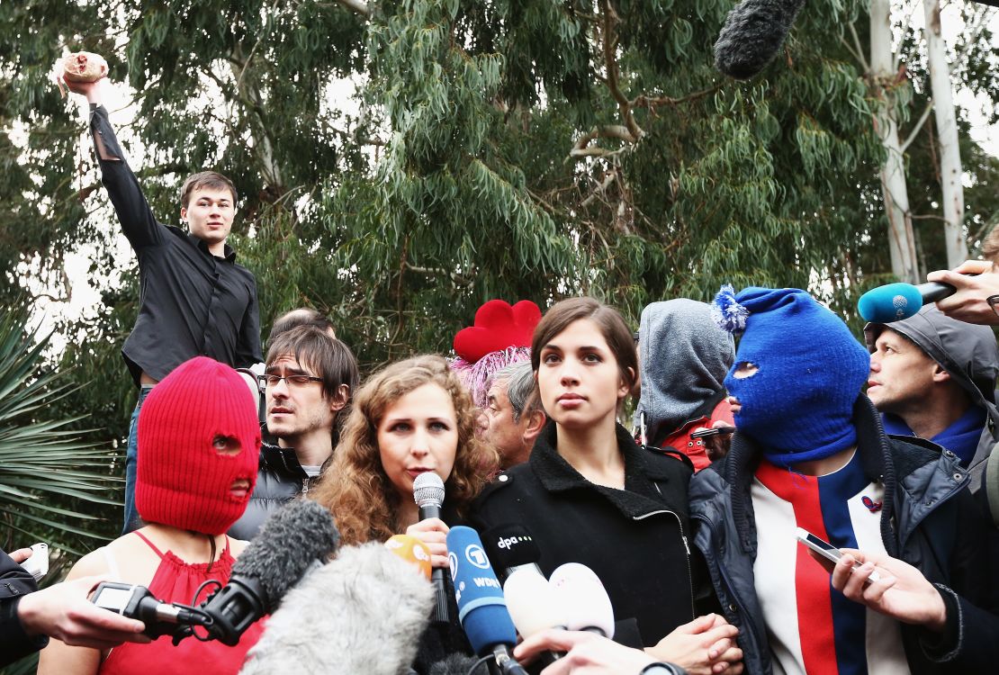 A member of a pro-Kremlin youth organization throws a chicken during a Pussy Riot press conference in Sochi in 2014.