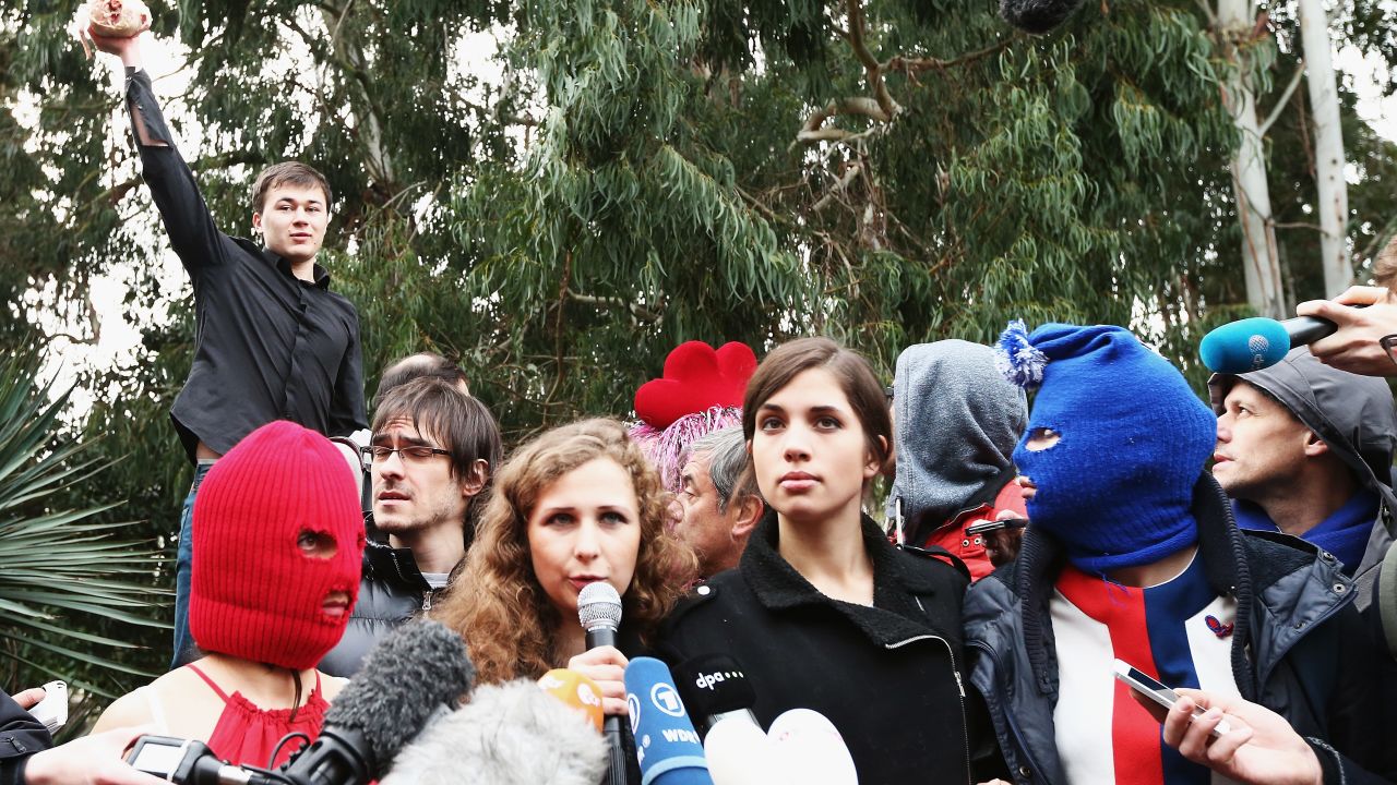 A member of a pro-Kremlin youth organization throws a chicken during a Pussy Riot press conference in Sochi in 2014.