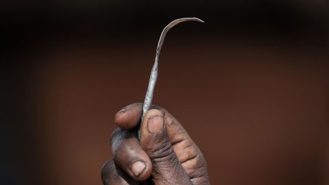 A former female genital mutilation (FGM) cutter shows a homemade tool from a nail used for FGM. 