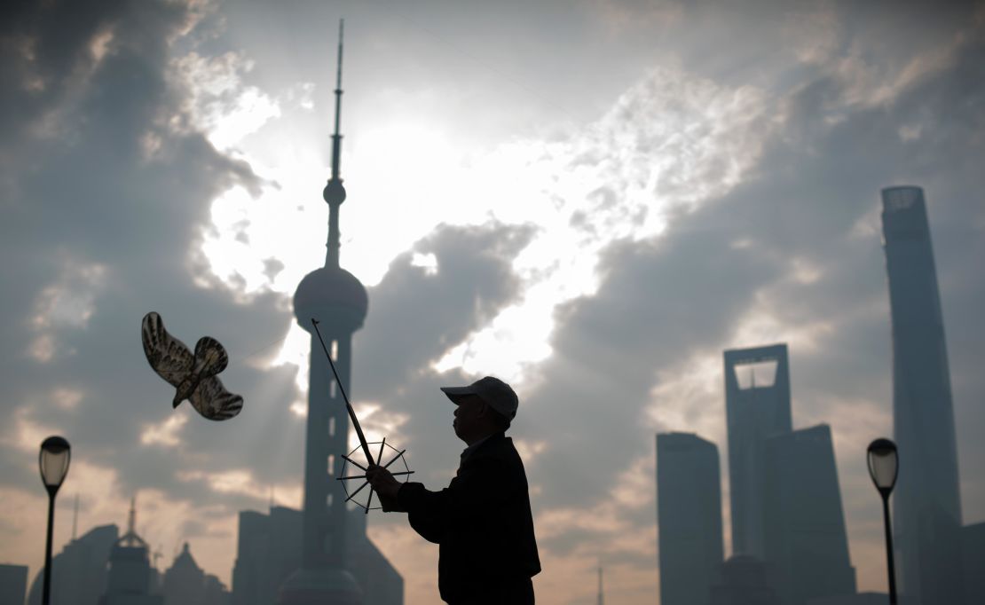 A man flies his kite in front of the financial district of Lujiazui in Shanghai.