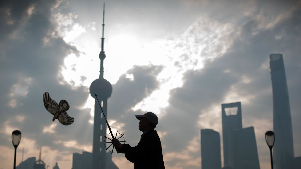 A man flies his kite in front of the financial district of Lujiazui in Shanghai.