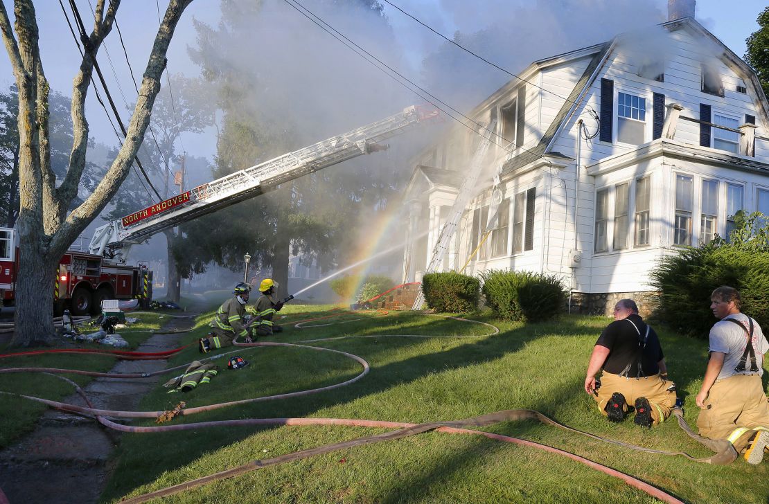 Firefighters battle a house fire Thursday in North Andover, Massachusetts.