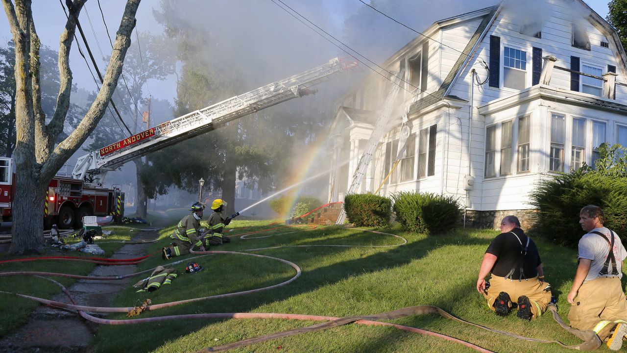Firefighters battle a house fire Thursday in North Andover, Massachusetts.