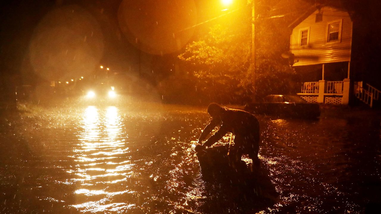 Michael Nelson floats in a makeshift boat after the Neuse River went over its banks and flooded his street during Hurricane Florence on Thursday in New Bern.