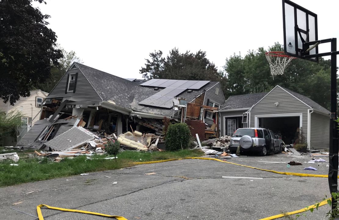 A house in Lawrence is reduced mostly to rubble Thursday after a series of explosions.