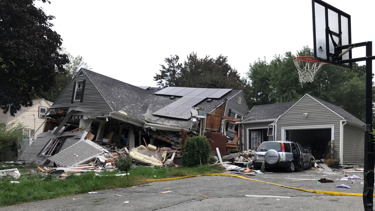 A house in Lawrence is reduced mostly to rubble Thursday after a series of explosions.