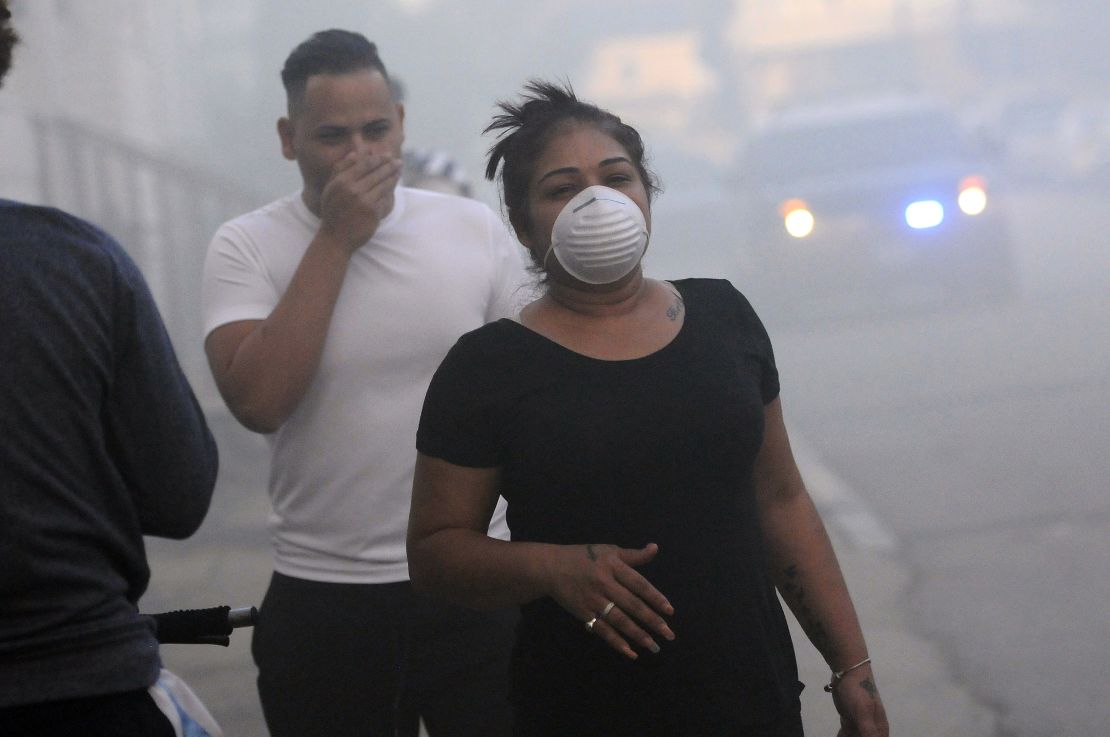 Residents protect their faces against the smoke while being evacuated Thursday in Lawrence, Massachusetts.