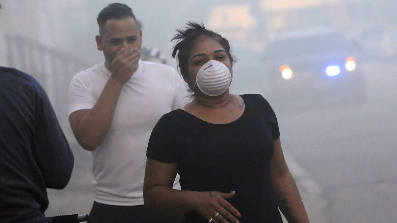 Residents protect their faces against the smoke while being evacuated Thursday in Lawrence, Massachusetts.