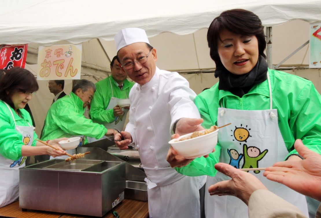 Sadakazu Tanigaki, then-secretary general of Japan's ruling Liberal Democratic Party (LDP) serves bowls of whale meat curry and oden -- a Japanese hot pot dish -- to party members at the LDP headquarters in Tokyo in 2015. 