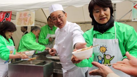 Sadakazu Tanigaki, then-secretary general of Japan's ruling Liberal Democratic Party (LDP) serves bowls of whale meat curry and oden -- a Japanese hot pot dish -- to party members at the LDP headquarters in Tokyo in 2015. 