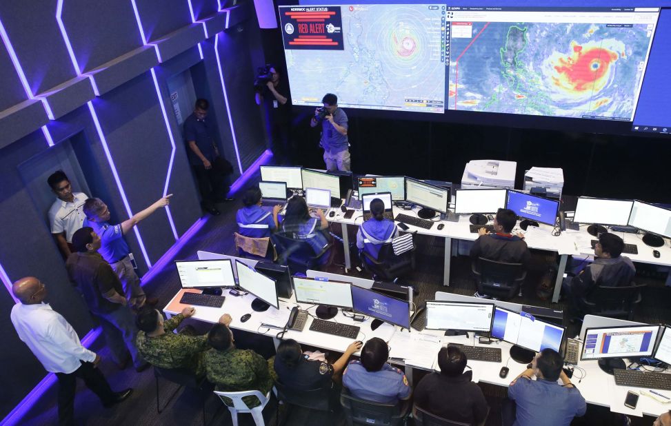 Duterte, second from left, observes the disaster agency's operation center in action in Manila on September 13.