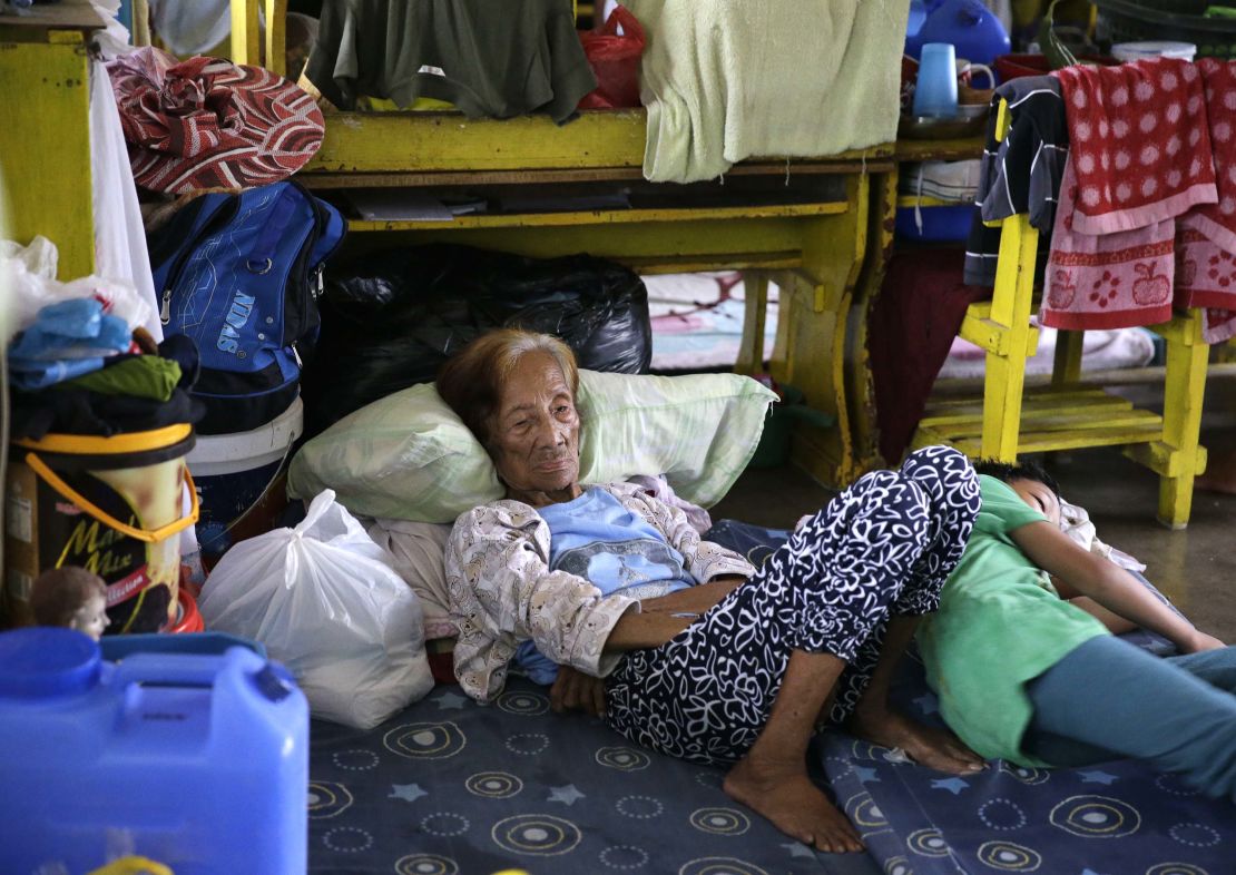 An evacuee rests inside an evacuation center as rains from Typhoon Mangkhut begin to affect Tuguegarao city, Cagayan province.