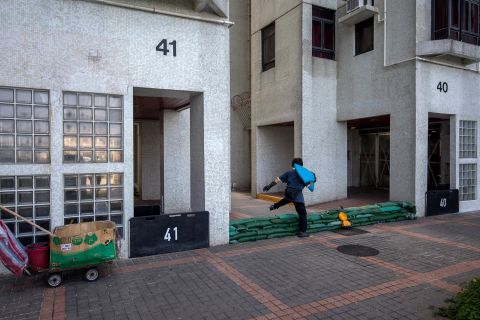 A worker steps over sandbags ahead of the typhoon's arrival in Hong Kong on September 14.