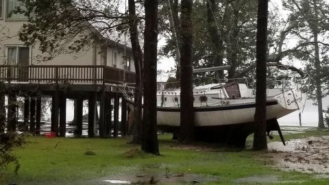 A boat is wedged in trees Friday in Oriental, North Carolina, in a photo from Angie Propst.