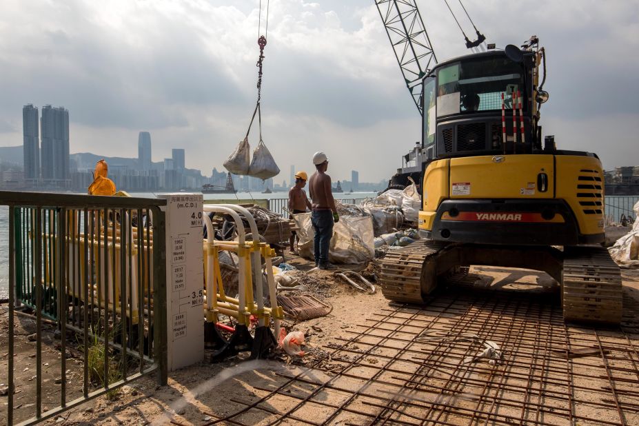 Workers lay sandbags at the waterfront of the Lei Yue Mun area of Hong Kong on September 14.