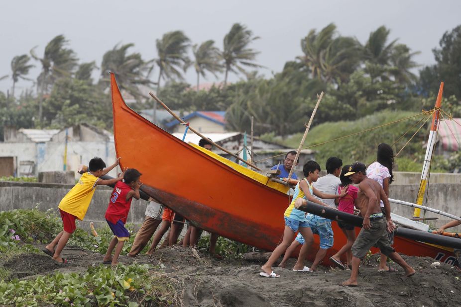 Fishermen secure a boat in Aparri before the storm arrives on September 14.