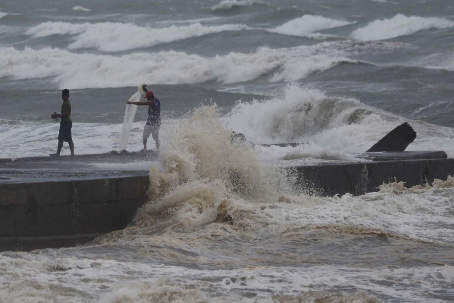 Fishermen work amid the rough seas near Aparri on September 14.