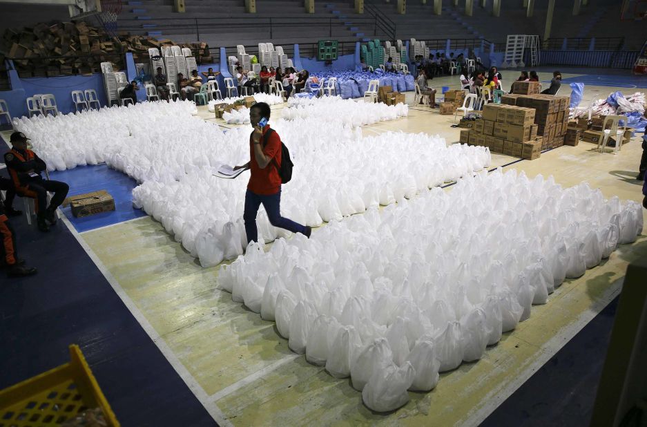 A volunteer moves through relief goods September 14 as Tuguegarao prepares for the typhoon's arrival.