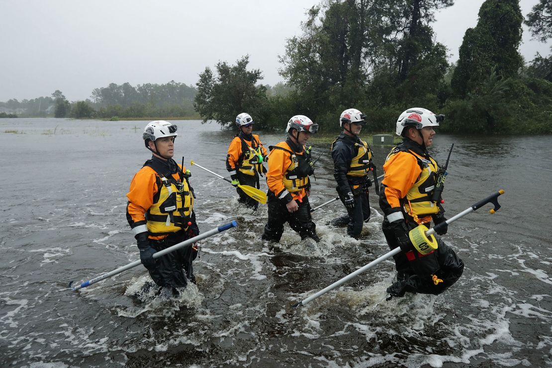 Members of the FEMA Urban Search and Rescue Task Force 4 from Oakland, California, search a flooded neighborhood for evacuees during Hurricane Florence on September 14, 2018 in Fairfield Harbour, North Carolina.