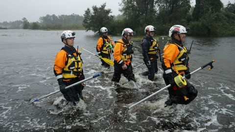 Members of the FEMA Urban Search and Rescue Task Force 4 from Oakland, California, search a flooded neighborhood for evacuees during Hurricane Florence on September 14, 2018 in Fairfield Harbour, North Carolina.