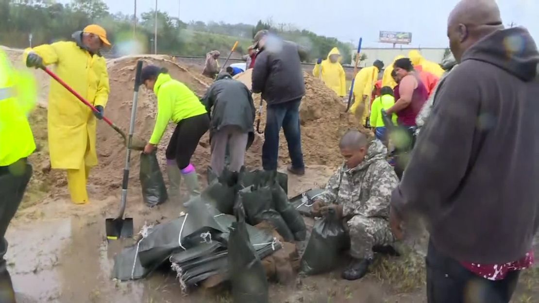 More than 100 people answered a Facebook call Friday, September 14, 2018, to help fill sandbags and barricade much of Lumberton, North Carolina, to prevent flooding from the Lumber River.