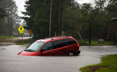 An abandoned van sits on a flooded road near New Bern on September 14.