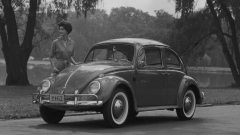 The Beetle gained cult-like status in the 1960s. Here, a model poses for a promotional image with a 1962 sedan.