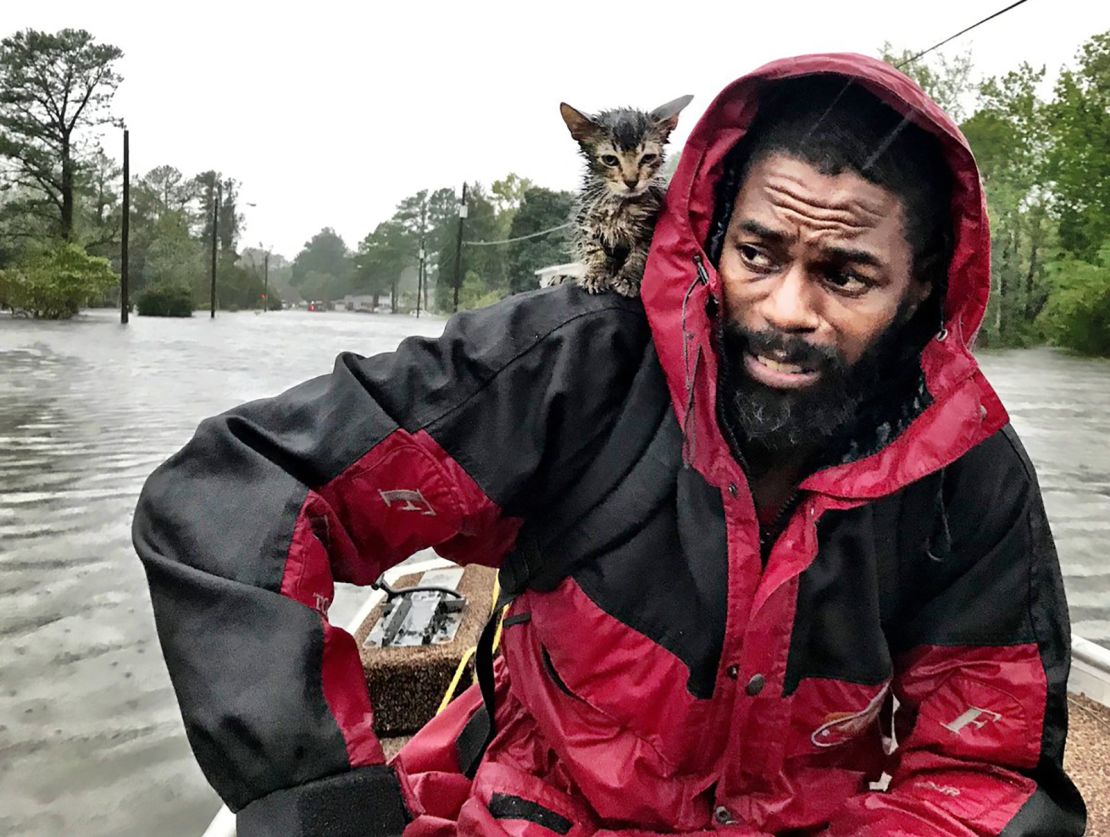 Robert Simmons Jr. and his kitten Survivor are rescued from floodwaters after Hurricane Florence dumped several inches of rain in the area overnight, Friday, September 14 in New Bern.