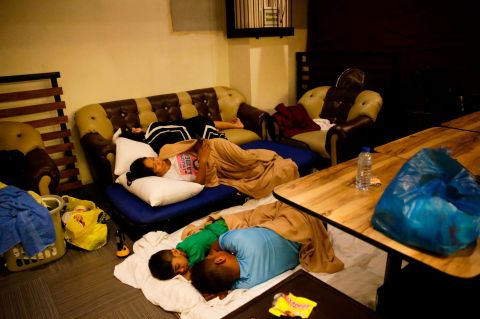 Guests sleep inside a hotel restaurant after strong winds damaged the roof of their room in Tuguegarao City on September 15.
