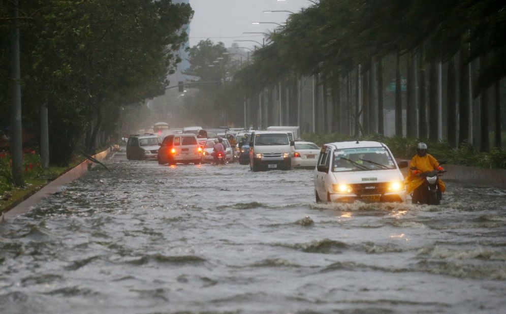 Motorists negotiate a flooded street in Manila on September 15.
