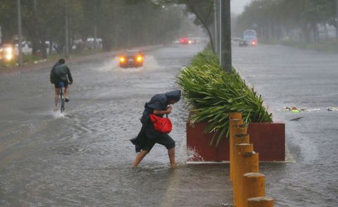 Commuters brave the elements in Manila on September 15.